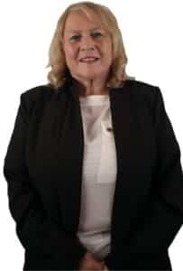 A woman in professional attire stands in front of a white background with the T. Samuel Estate Agents logo in the top left corner.